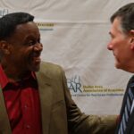 Dulles Area Association of Realtors members shaking hands and having a conversation