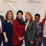 Dulles Area Association of Realtors members shaking hands and meeting for a photo