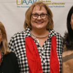 Three Dulles Area Association of Realtors members standing for a photo