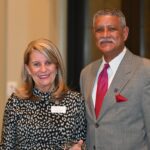 Dulles Area Association of Realtors President Phyllis Stakem handing a plaque to Dwight Brooks
