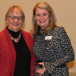 Dulles Area Association of Realtors President Phyllis Stakem handing a plaque to Brenda Mac