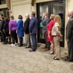 Dulles Area Association of Realtors raising their arms for a swearing