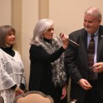 Dulles Area Association realtors passing down the award gavel through the lineup of members