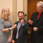 Dulles Area Association realtors sharing the award gavel with their team for a photograph