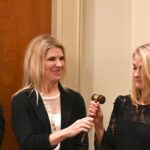 phyllis stakem sharing the award gavel and meeting with board members