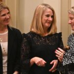 phyllis stakem holding a gavel and meeting with board members