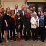 dulles area association of realtors gathered together for a company photo at the holiday park