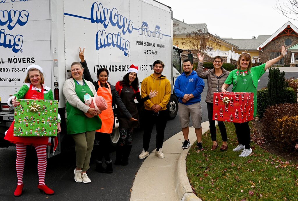 myguys moving truck crew wearing christmas wear as they delivery gifts