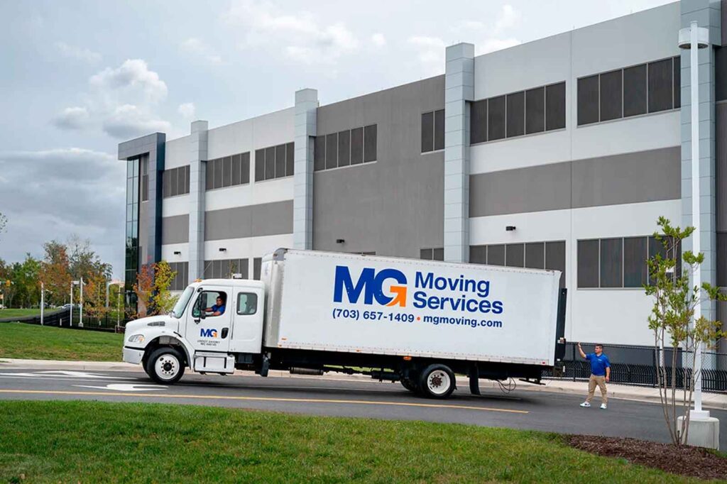 MG Moving Services Truck outside the warehouse