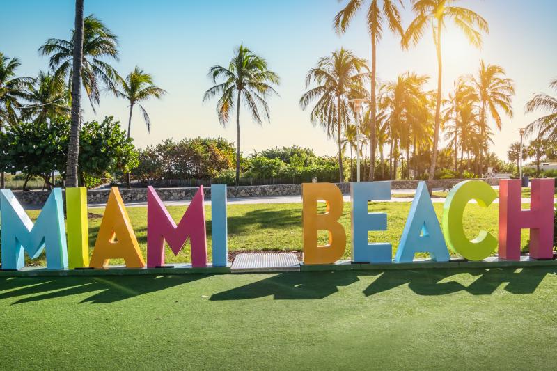 Colorful Miami beach sign in Lummus park at sunset, Miami, Florida.