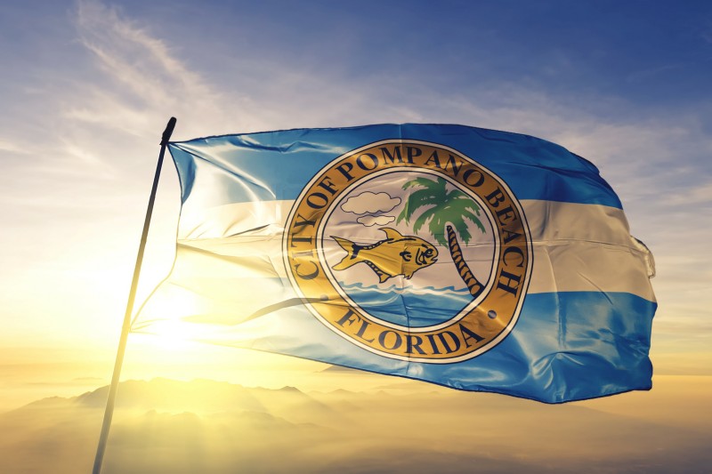 pompano beach city flag against sunset