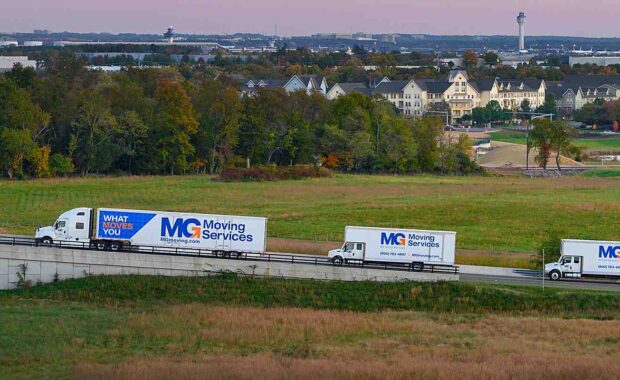 three mg moving trucks on the road
