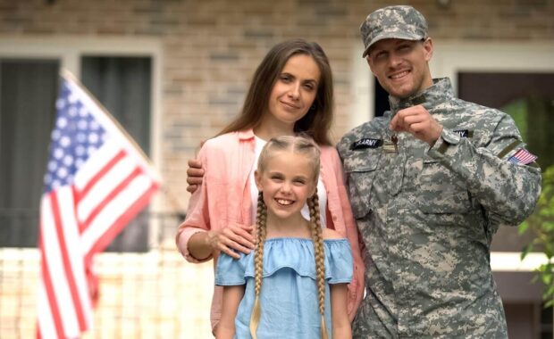 US military man with family showing keys from house